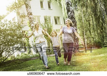 Girl being swung by mother and grandmother View Large Photo Image Stock Photo - Girl being swung by mother and grandmother. Fotosearch