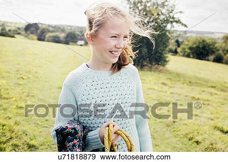 Girl in field, smiling View Large Photo Image Stock Photo - Girl in field, smiling. Fotosearch