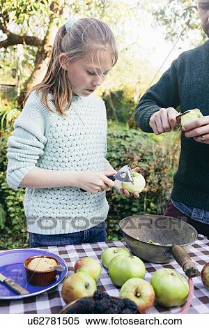 Girl peeling apples View Large Photo Image Stock Photography - Girl peeling apples. Fotosearch