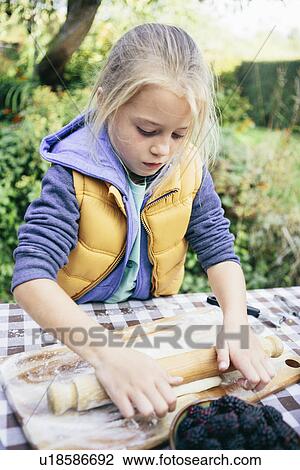 Girl rolling pastry View Large Photo Image Stock Image - Girl rolling pastry. Fotosearch