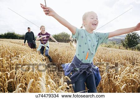 Girl running through field with arms out View Large Photo Image Picture - Girl running through field with arms out. Fotosearch