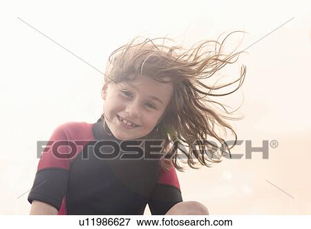 Girl wearing wetsuit looking at camera, smiling View Large Photo Image Stock Photo - Girl wearing wetsuit looking at camera, smiling. Fotosearch