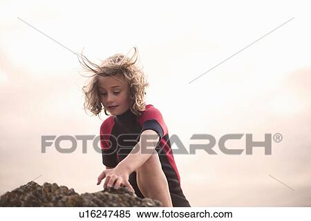 Girl wearing wetsuit, playing View Large Photo Image Stock Photography - Girl wearing wetsuit, playing. Fotosearch