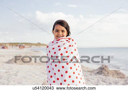 Girl wrapped in spotted towel on beach, Tuscany, Italy View Large Photo Image Stock Image - Girl wrapped in spotted towel on beach, Tuscany, Italy. Fotosearch