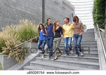 Group of friends walking down steps together View Large Photo Image Picture - Group of friends walking down steps together. Fotosearch