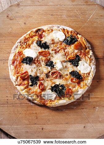 Italian spinach and ricotta pizza with plum tomatoes View Large Photo Image Stock Photo - Italian spinach and ricotta pizza with plum tomatoes. Fotosearch