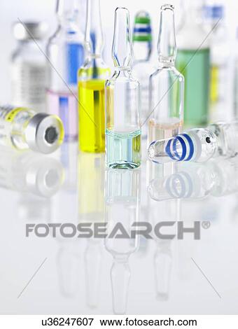 Stock Photo - Large group of drugs including vials, ampules and vaccines illustrating medical research. Fotosearch