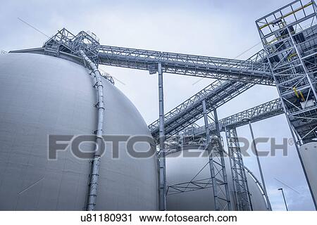 Stock Image - Low angle view of biomass facility. Fotosearch