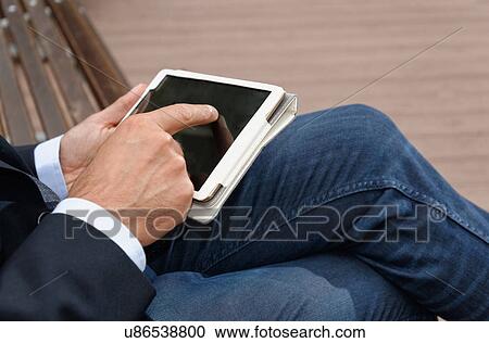 Man using digital tablet, focus on hands View Large Photo Image Stock Image - Man using digital tablet, focus on hands. Fotosearch