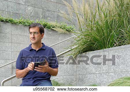 Man using smartphone View Large Photo Image Stock Image - Man using smartphone. Fotosearch