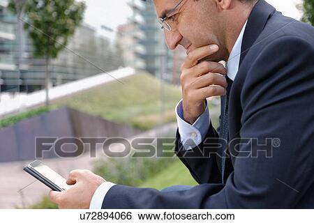 Stock Photograph - Man using smartphone. Fotosearch