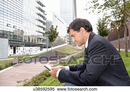 Stock Photography - Man using smartphone. Fotosearch