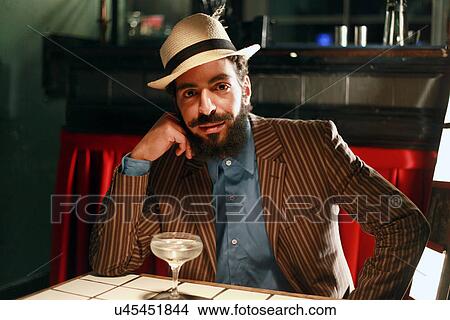 Man with cocktail at bar View Large Photo Image Picture - Man with cocktail at bar. Fotosearch