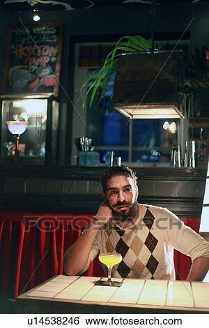Man with cocktail at bar View Large Photo Image Stock Photograph - Man with cocktail at bar. Fotosearch