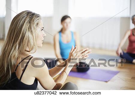 Mature female tutor with hands together in pilates class View Large Photo Image Stock Image - Mature female tutor with hands together in pilates class. Fotosearch