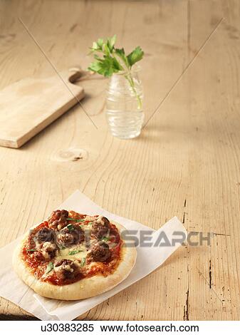 Meatball and cheese pizza on greaseproof paper View Large Photo Image Stock Photography - Meatball and cheese pizza on greaseproof paper. Fotosearch