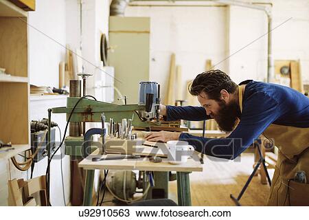 Mid adult craftsman using machine in pipe organ workshop View Large Photo Image Stock Image - Mid adult craftsman using machine in pipe organ workshop. Fotosearch