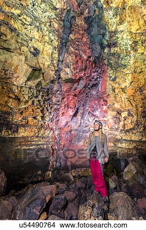 Picture - Mid adult woman inside Thrihnjukagigur volcano, Blafjoll, Iceland. Fotosearch