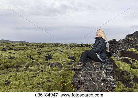 Mid adult woman sitting on rocks, looking at view, Blafjoll, Iceland View Large Photo Image Stock Photo - Mid adult woman sitting on rocks, looking at view, Blafjoll, Iceland. Fotosearch
