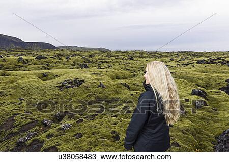 Stock Image - Mid adult woman taking in view, Blafjoll, Iceland. Fotosearch