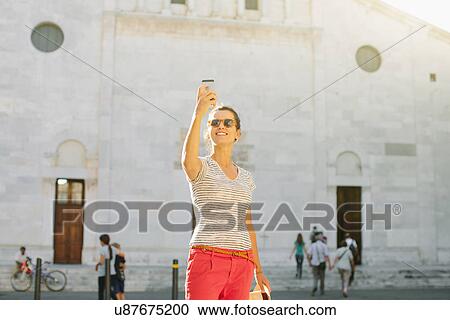 Mid adult woman taking selfie in front of church with smartphone, Tuscany, Italy View Large Photo Image Stock Image - Mid adult woman taking selfie in front of church with smartphone, Tuscany, Italy. Fotosearch