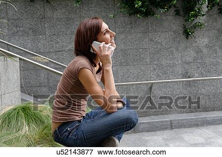 Mid adult woman using mobile phone View Large Photo Image Stock Photo - Mid adult woman using mobile phone. Fotosearch