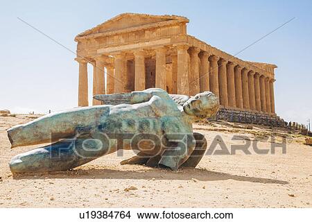 Picture - Modern sculpture of Icarus in front of the Temple of Concordia, Valley of the Temples, Sicily, Italy. Fotosearch