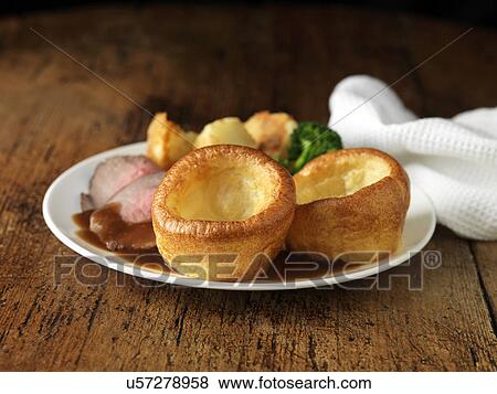 Stock Photo - Plate of roast beef, yorkshire puddings, broccoli and potatoes. Fotosearch