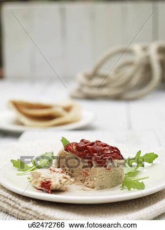 Stock Photograph - Plate of tuna terrine and roasted red peppers with pita bread and rocket garnish. Fotosearch