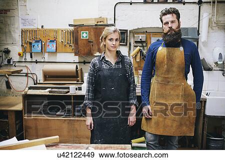 Stock Photo - Portrait of craftsman and woman in organ workshop. Fotosearch