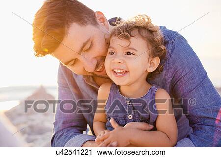 Portrait of father and toddler daughter at beach, Tuscany, Italy View Large Photo Image Stock Image - Portrait of father and toddler daughter at beach, Tuscany, Italy. Fotosearch