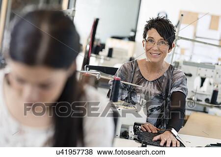 Portrait of mature seamstress using sewing machine in workshop View Large Photo Image Stock Photo - Portrait of mature seamstress using sewing machine in workshop. Fotosearch