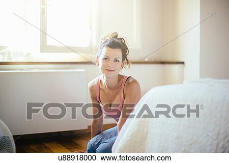 Portrait of mid adult woman kneeling on bedroom floor View Large Photo Image Stock Image - Portrait of mid adult woman kneeling on bedroom floor. Fotosearch