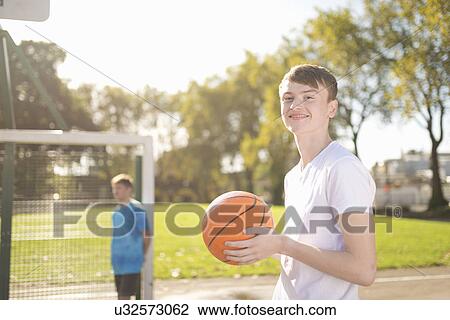 Portrait of smiling young male basketball player on basketball court View Large Photo Image Stock Image - Portrait of smiling young male basketball player on basketball court. Fotosearch