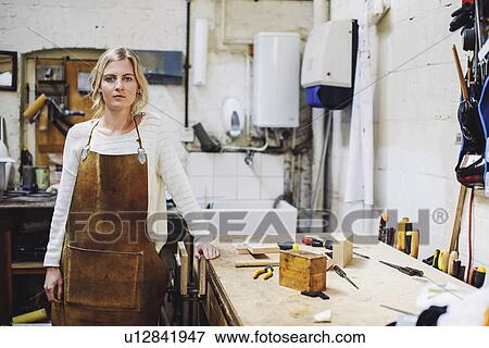 Portrait of young craftswoman leaning on workbench in organ workshop View Large Photo Image Stock Photo - Portrait of young craftswoman leaning on workbench in organ workshop. Fotosearch