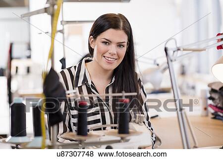 Portrait of young female seamstress in workshop View Large Photo Image Stock Photo - Portrait of young female seamstress in workshop. Fotosearch