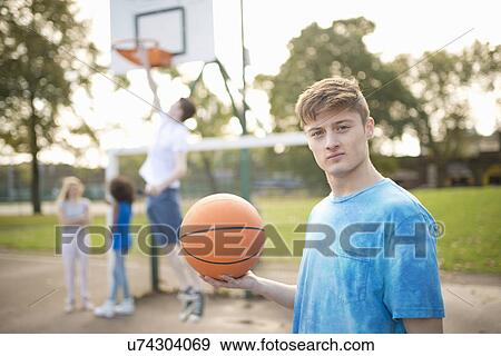 Portrait of young male basketball player holding basketball View Large Photo Image Stock Photo - Portrait of young male basketball player holding basketball. Fotosearch