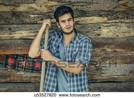Portrait of young male farmer with pitchfork, Premosello, Verbania, Piemonte, Italy View Large Photo Image Stock Image - Portrait of young male farmer with pitchfork, Premosello, Verbania, Piemonte, Italy. Fotosearch