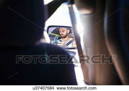 Reflection of young man in car wing mirror View Large Photo Image Picture - Reflection of young man in car wing mirror. Fotosearch