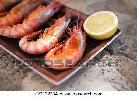 Picture - Restaurant dish of fresh shrimps and lemon, Mallorca, Spain. Fotosearch