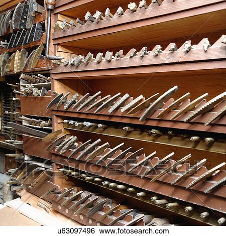 Stock Photograph - Rows of shelves and tools in traditional bookbinding workshop. Fotosearch