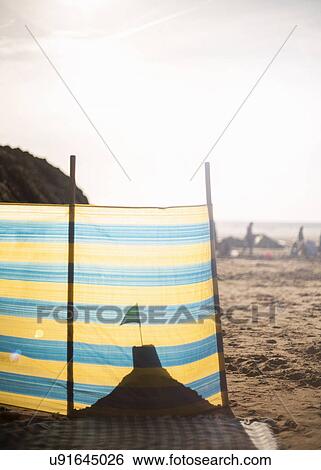 Sandcastle behind windbreak on beach View Large Photo Image Stock Photograph - Sandcastle behind windbreak on beach. Fotosearch