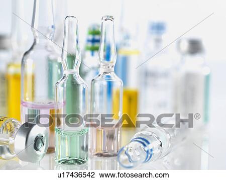 Stock Image - Selection of drugs including vials, ampules and vaccines illustrating medical research. Fotosearch