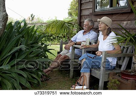 Senior couple relaxing by wooden cabin, Raglan, New Zealand View Large Photo Image Stock Image - Senior couple relaxing by wooden cabin, Raglan, New Zealand. Fotosearch