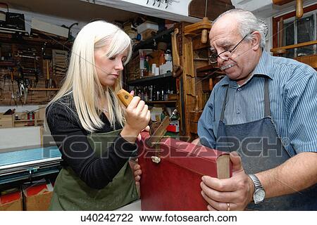 Senior man and young woman applying gold leaf to book spine in traditional bookbinding workshop View Large Photo Image Stock Image - Senior man and young woman applying gold leaf to book spine in traditional bookbinding workshop. Fotosearch