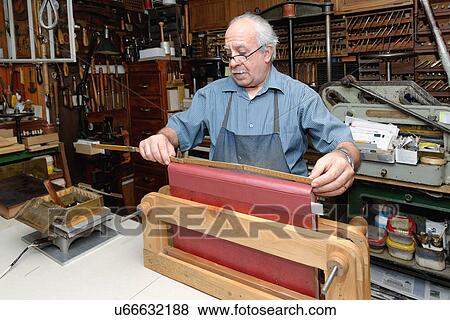Senior man measuring book spine in traditional bookbinding workshop View Large Photo Image Stock Photo - Senior man measuring book spine in traditional bookbinding workshop. Fotosearch