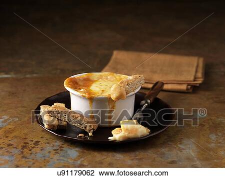 Stock Image - Smoked haddock fondue with bread slices. Fotosearch