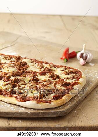 Stock Photo - Spicy pizza with red chillies, garlic and cheese. Fotosearch