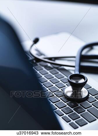 Stethoscope on top of laptop computer keyboard on doctors desk View Large Photo Image Stock Image - Stethoscope on top of laptop computer keyboard on doctors desk. Fotosearch