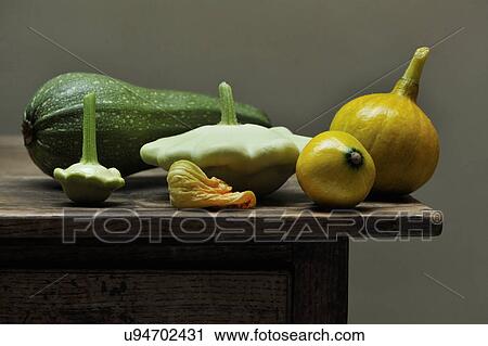 Stock Image - Still life of vegetables including marrow, courgette flower and gourds. Fotosearch